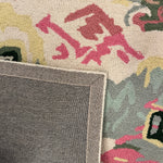 the reverse side a of an Old Peking pink and green rug with chinoiserie motifs from madcap cottage