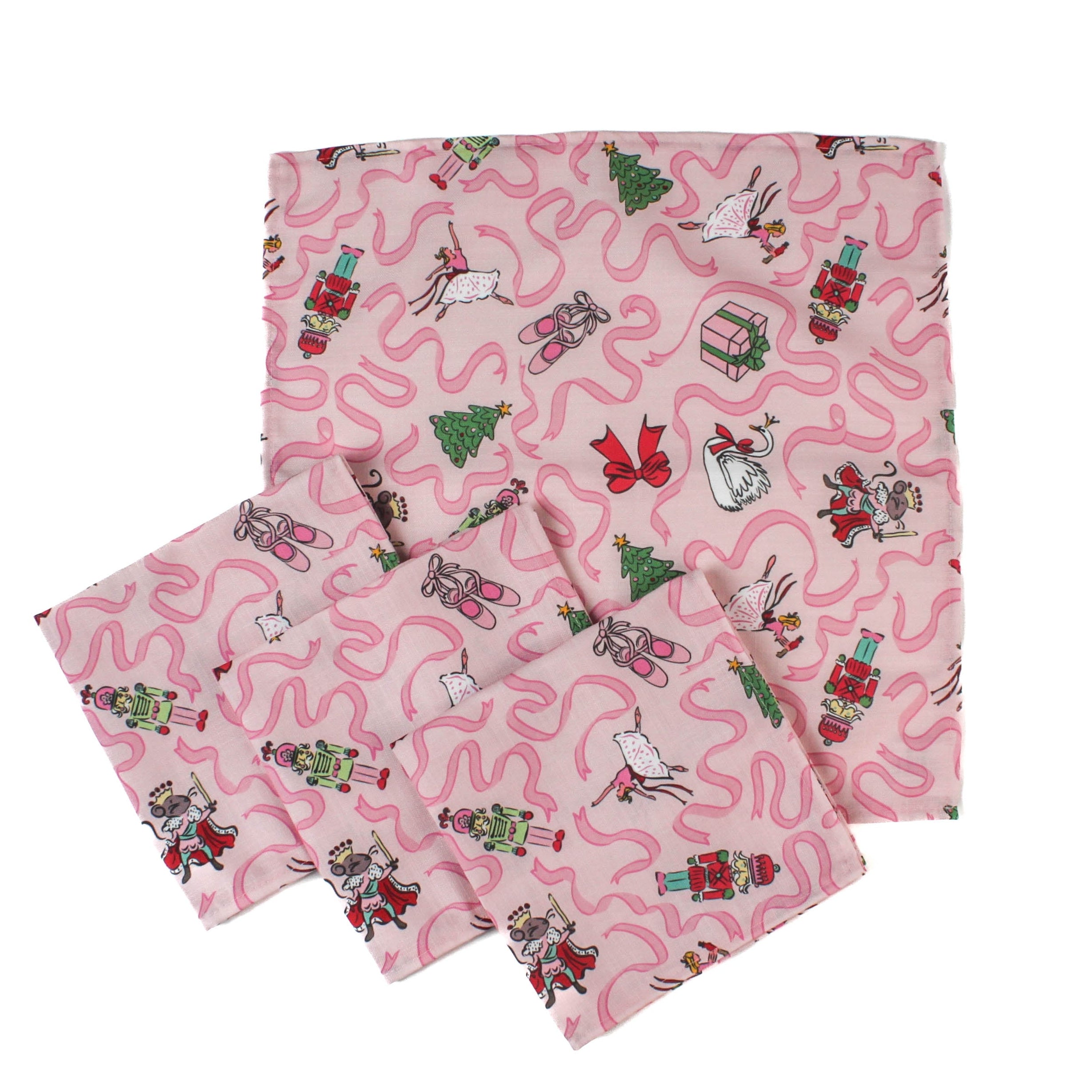 set of 4 Nutcracker pink christmas napkins featuring motifs of ballerinas, ribbons, christmas trees and nutcrackers on a white background. 