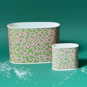 Empty duo of Ribbons Pink and Green caddies in large and small on a green background