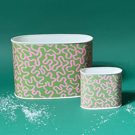 Empty duo of Ribbons Pink and Green caddies in large and small on a green background