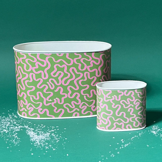 Empty duo of Ribbons Pink and Green caddies in large and small on a green background