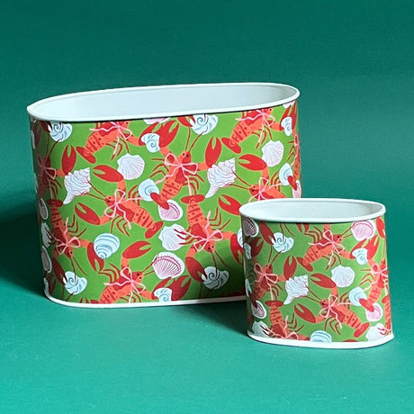 Empty duo of Rock Lobster caddies in large and small on a green background