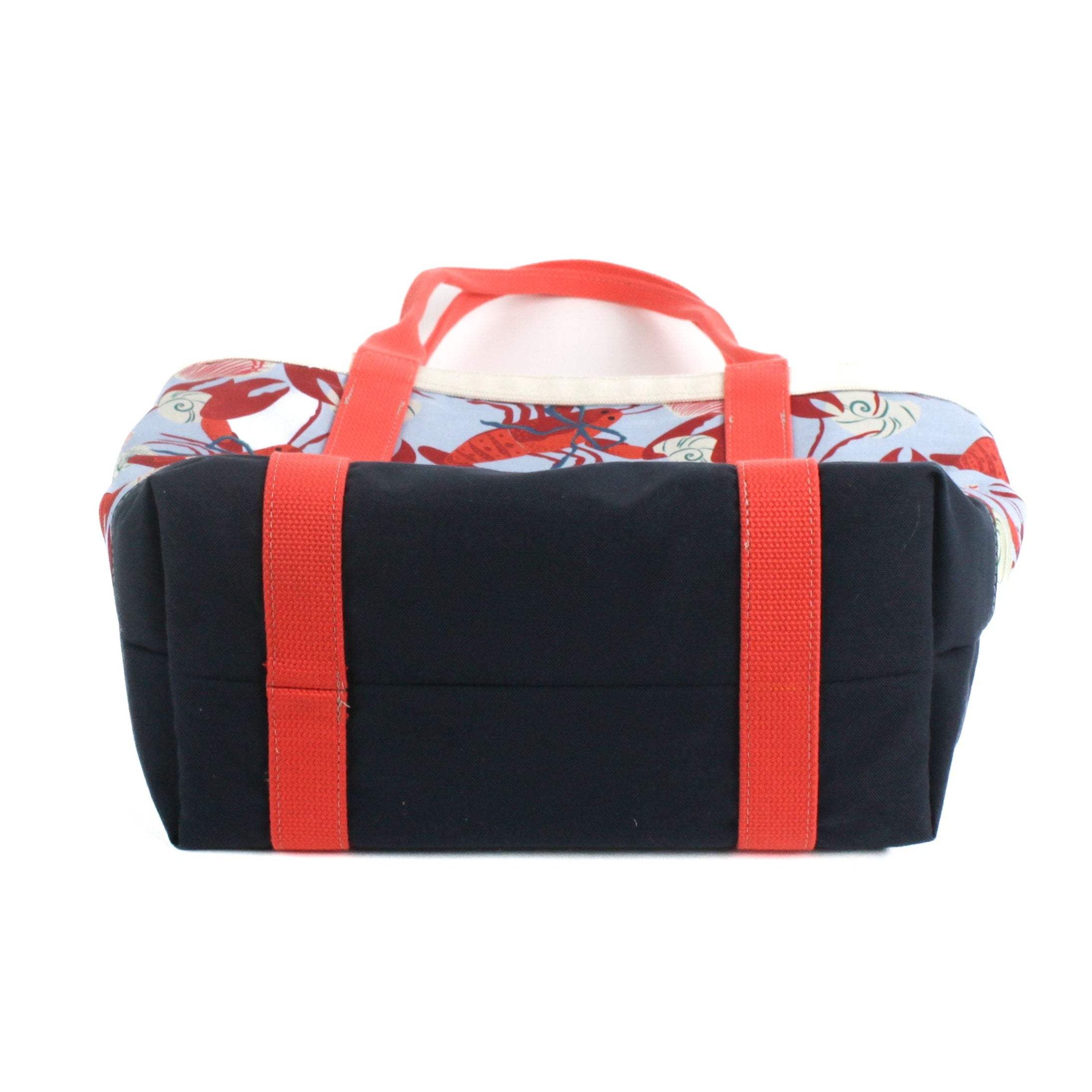 a large Rock Lobster canvas tote bag with a lobster pattern showing the bottom, against a white background.
