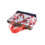 a large Rock Lobster canvas tote bag with a lobster pattern showing the bottom, against a white background.
