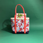 Rock Lobster large canvas tote bag with red straps and blue fabric with a repeating lobster and shell motif.