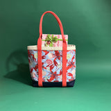 Rock Lobster large canvas tote bag with red straps and blue fabric with a repeating lobster and shell motif.
