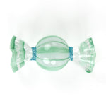 Green glass candy with blue ribbon glitter detail on a white background