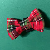 a Royal Stewart Red/Green Plaid Dog/Cat Bowties placed on a green surface