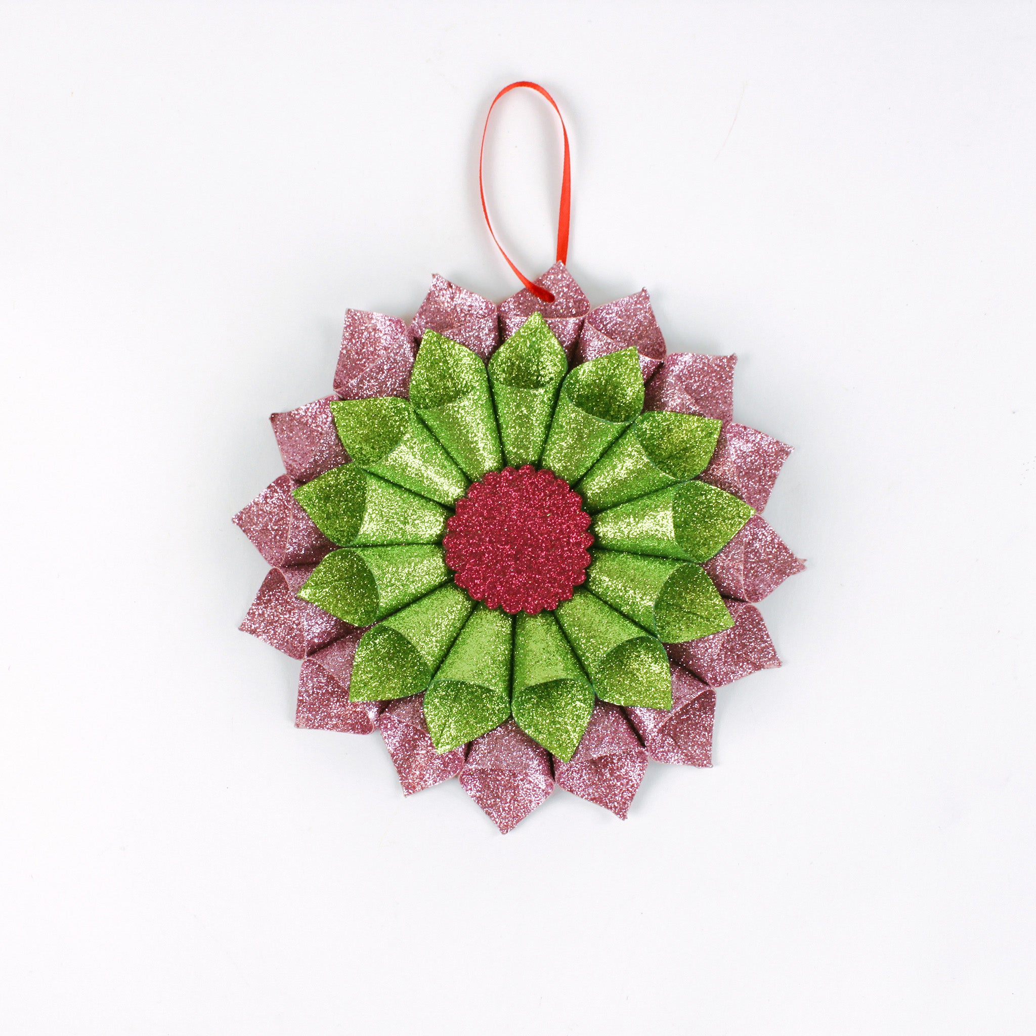 ruffled paper Christmas ornaments in shimmering green and purple glitter with red centers