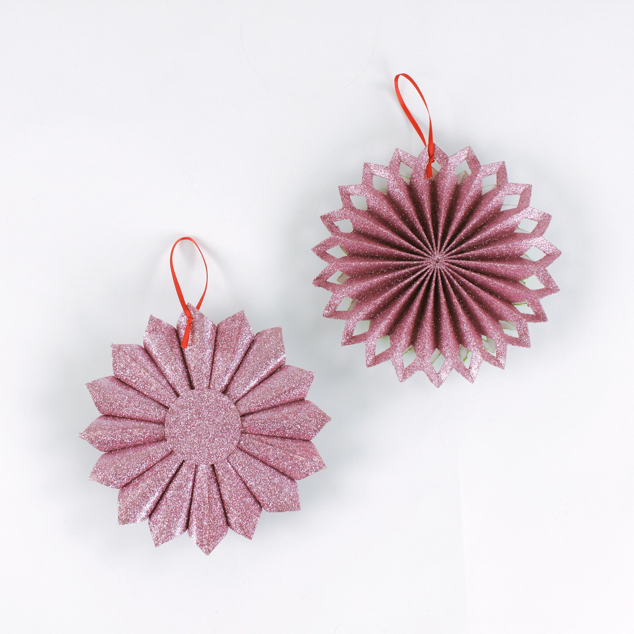 back of Set of two ruffled paper Christmas ornaments in shimmering green and purple glitter with red centers