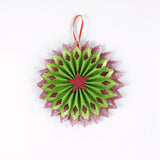 ruffled paper Christmas ornaments in shimmering green and purple glitter with red centers