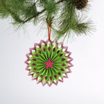 ruffled paper Christmas ornaments in shimmering green and purple glitter with red centers