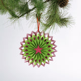 ruffled paper Christmas ornaments in shimmering green and purple glitter with red centers
