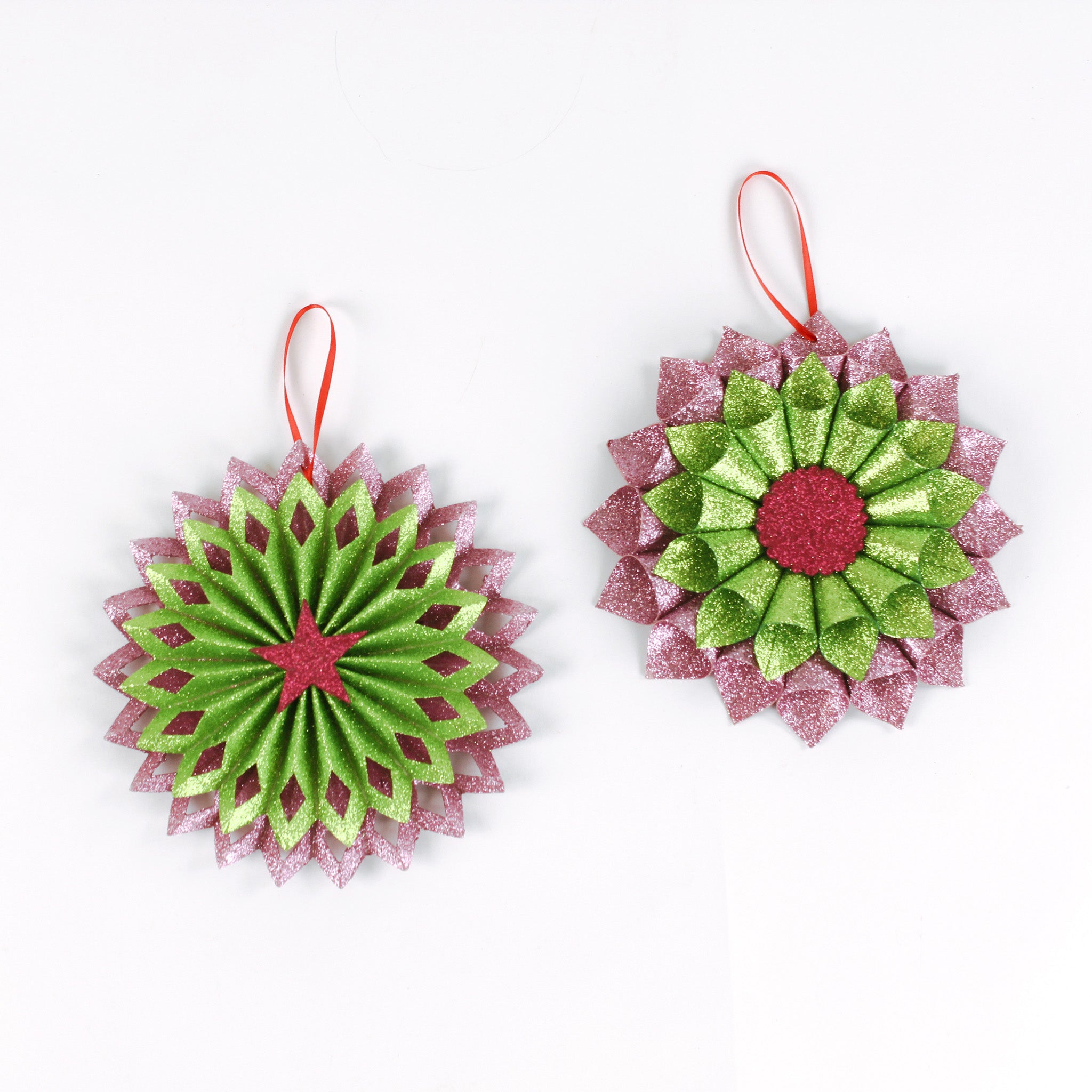 Set of two ruffled paper Christmas ornaments in shimmering green and purple glitter with red centers