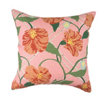 Pink tropical outdoor pillow with vibrant orange floral accents.