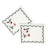 white scalloped cocktail napkins with embroidered Santa and holly design