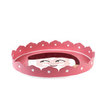 side of a Hand-Painted Metal Christmas Santa Tray featuring a cheerful Santa Claus face with a red hat on a pink circular background with scalloped edges.