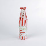 Madcap Cottage Red and white striped bottle bag with a text "Be Naughty! Save Santa the trip" on a white background