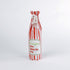 Madcap Cottage Red and white striped bottle bag with a text "Be Naughty! Save Santa the trip" on a white background