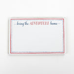 Luxe large notepad with quote ‘Bring the Adventure Home’ in blue and red typography, bordered with dotted design for chic desk stationery. placed in a white background