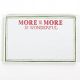 Luxe large notepad with quote ‘More of More is Wonderful’ in red lettering, featuring a dotted border and green trim, perfect for stylish note-taking. placed in a white background