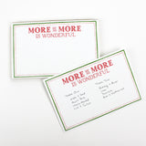 Luxe large notepad with quote ‘More of More is Wonderful’ in red lettering, featuring a dotted border and green trim, perfect for stylish note-taking. placed in a white background