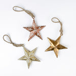 Three meal star christma ornaments in different colors on a white backgroud