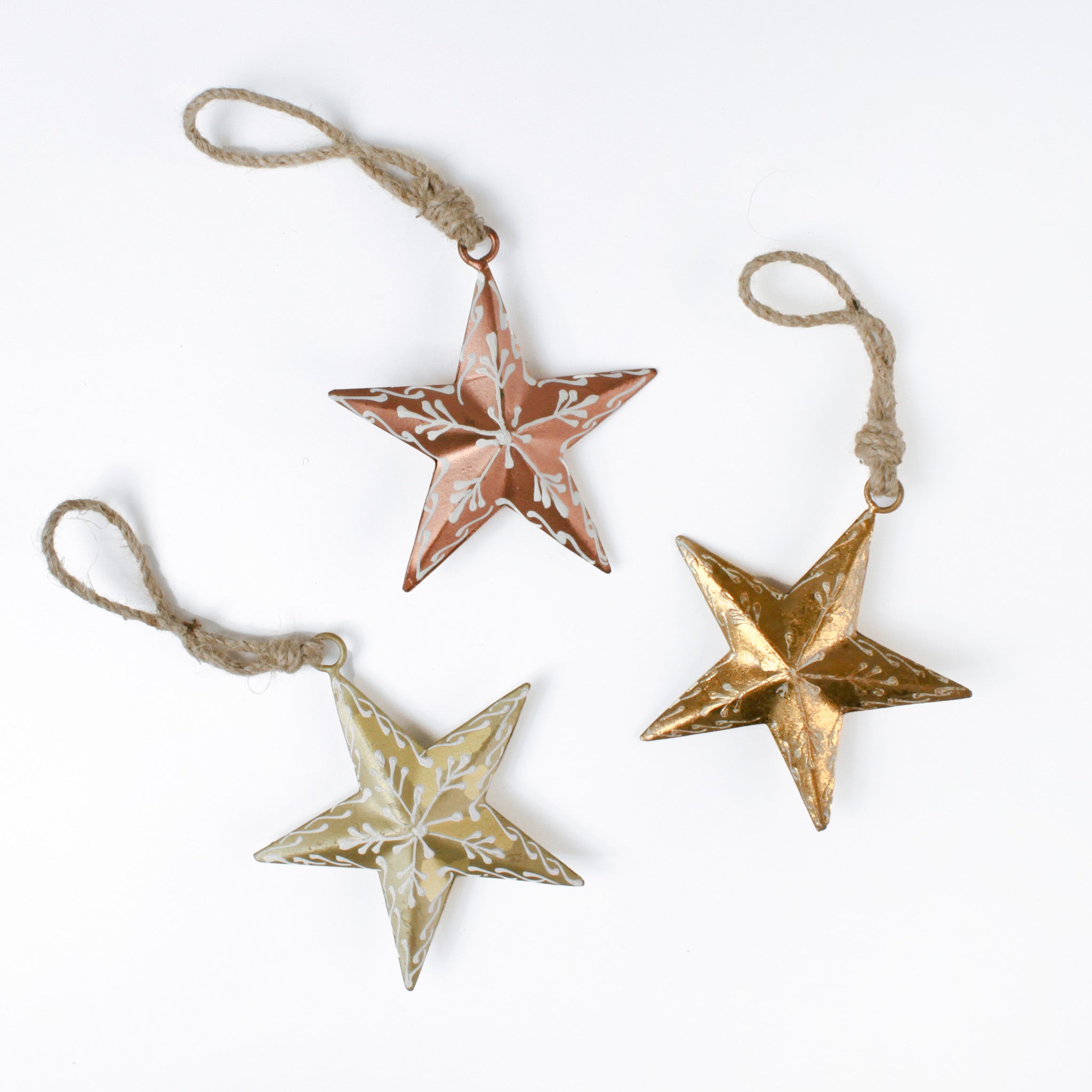Three meal star christma ornaments in different colors on a white backgroud