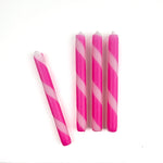 4 pcs of pink and white stripe candles on a white background
