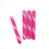 4 pcs of pink and white stripe candles on a white background