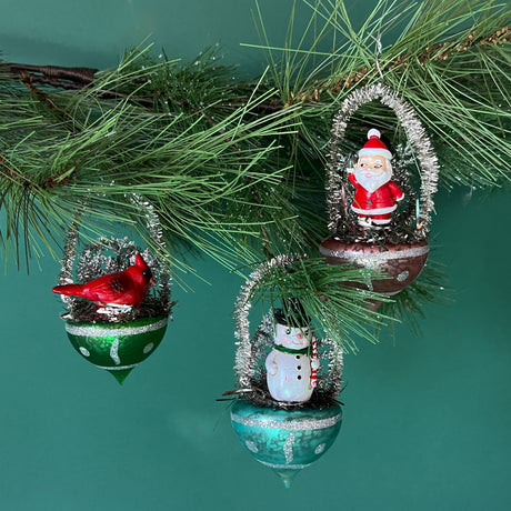 Three hanging basket christmas tree ornaments featuring a santa, cardinal and a snowman