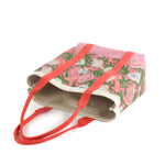 large Shell Seekers canvas tote bags with pink fabric with a repeating seaweed and shell motif.
