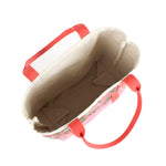 the image shows the inside of a large Shell Seekers canvas tote bags with pink fabric with a repeating seaweed and shell motif.