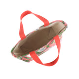 the image shows the inside of a small Shell Seekers canvas tote bags with pink fabric with a repeating seaweed and shell motif.