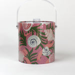 Shell Seekers is a pink acrylic ice bucket from madcap cottage covered in shell and seaweed motifs featuring a clear handle and lid