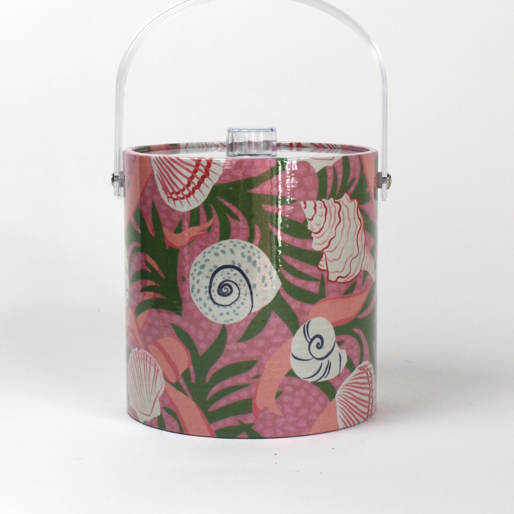 Shell Seekers is a pink acrylic ice bucket from madcap cottage covered in shell and seaweed motifs featuring a clear handle and lid
