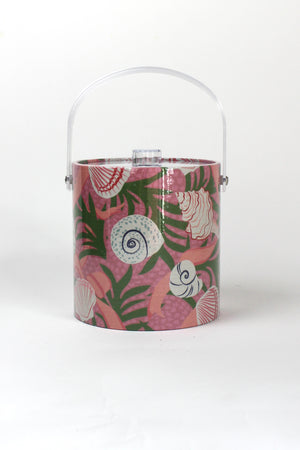 Shell Seekers is a pink acrylic ice bucket from madcap cottage covered in shell and seaweed motifs featuring a clear handle and lid