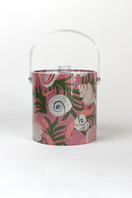 a pink acrylic ice bucket from madcap cottage covered in shell and seaweed motifs