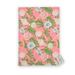Madcap Cottage Shells and Ribbons cotton tea towel featuring colorful seashells, pink ribbons, and green tropical foliage on a vibrant pink background.