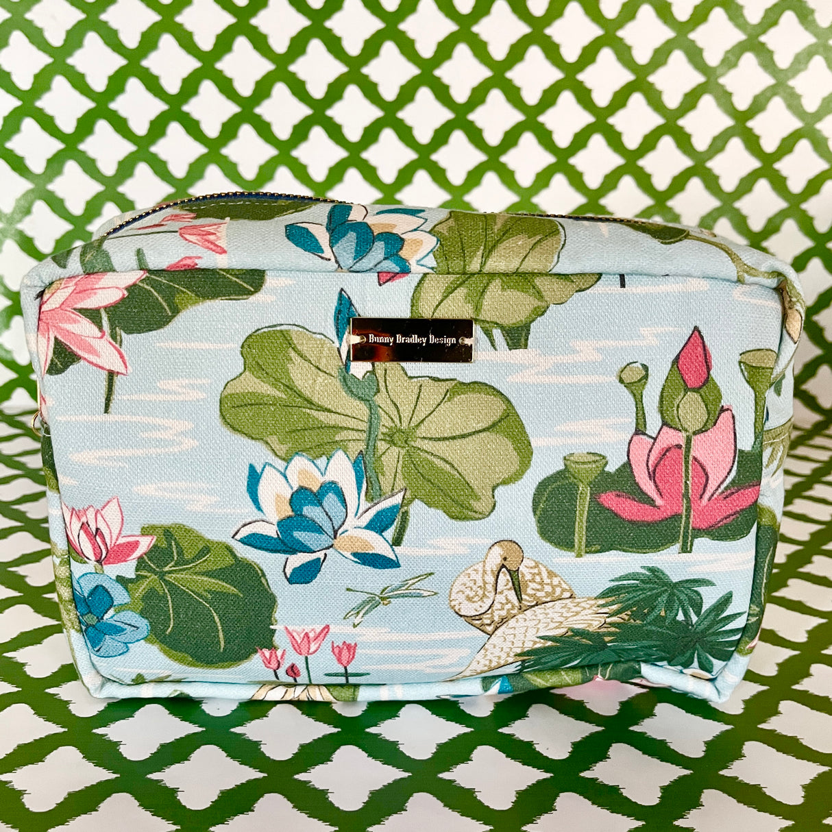 Side view of Meadow Club toiletry bag in sky blue features a lily pond pattern