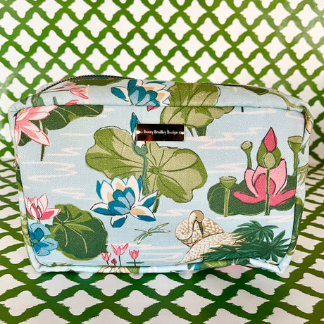 Side view of Meadow Club toiletry bag in sky blue features a lily pond pattern