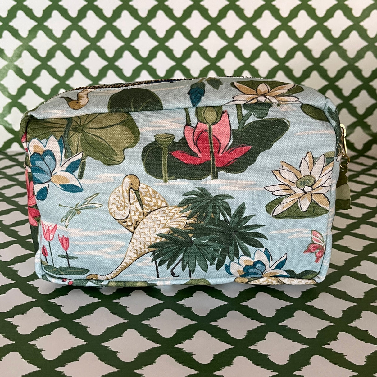 Side view of Meadow Club toiletry bag in sky blue features a lily pond pattern