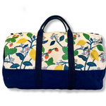 A side view of Strawberry Hill canvas duffel bag with a multicolored floral pattern and a zipper.