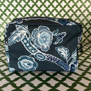 Side view of Temple Garden toiletry bag in navy blue features light blue floral motif.
