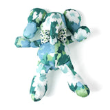 Green and blue patterned stuffed elephant toy with a matching bow.