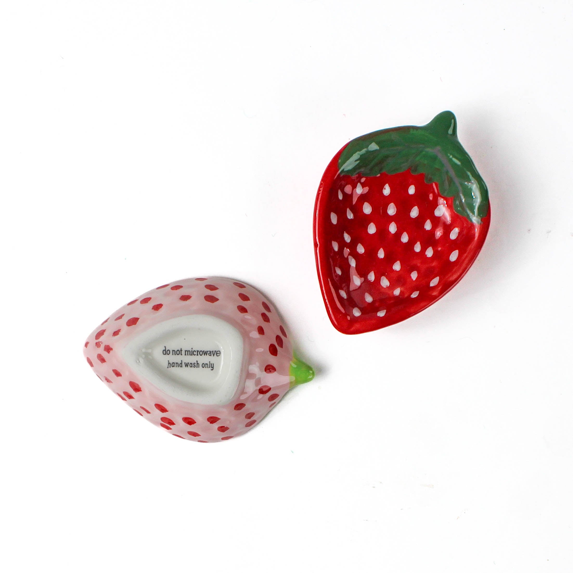 pink and red ceramic strawberry bowls on a white background