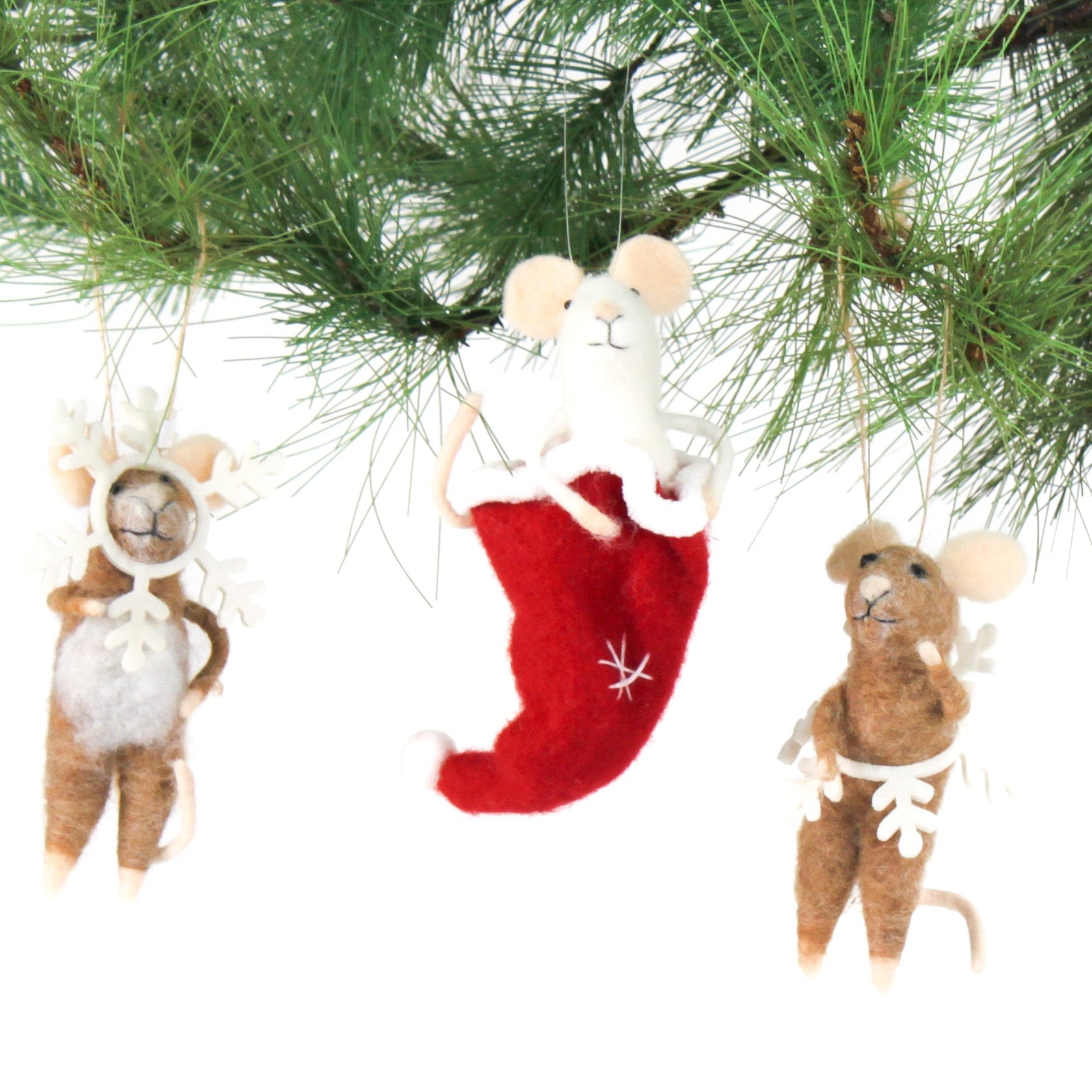 Three small felt mice christmas ornaments hanging on a green pine branch