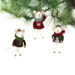 Three felt mouse ornaments wearing cozy sweaters with festive designs—a snowman, a tree, and a snowflake—each topped with a tiny acorn cap and ready to hang.