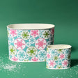 Empty duo of Snowflake Wonderland Christmas caddies in large and small on a green background