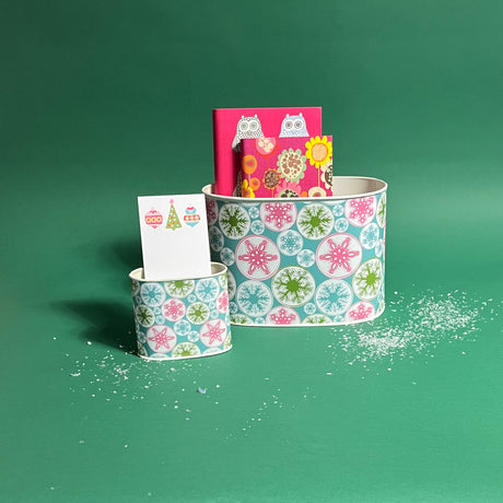 Snowflake Wonderland filled duo of Christmas caddies in large and small on a green background